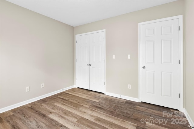 370 Running Briar Rd, Fletcher, NC 28732 - unfurnished bedroom with baseboards, wood finished floors, and a closet