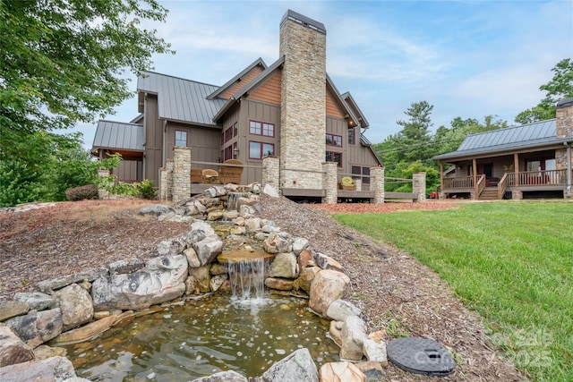 4862 Pinnacle Mountain Rd, Zirconia, NC 28790 - back of property with a chimney, board and batten siding, a standing seam roof, a metal roof, and a yard