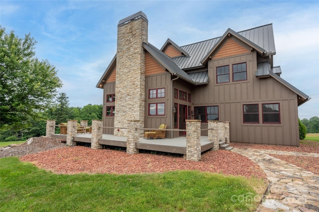 4862 Pinnacle Mountain Rd, Zirconia, NC 28790 - back of house featuring a standing seam roof, a deck, a metal roof, a chimney, and board and batten siding