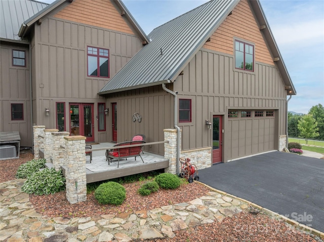 4862 Pinnacle Mountain Rd, Zirconia, NC 28790 - view of front facade with a metal roof, asphalt driveway, a standing seam roof, and stone siding