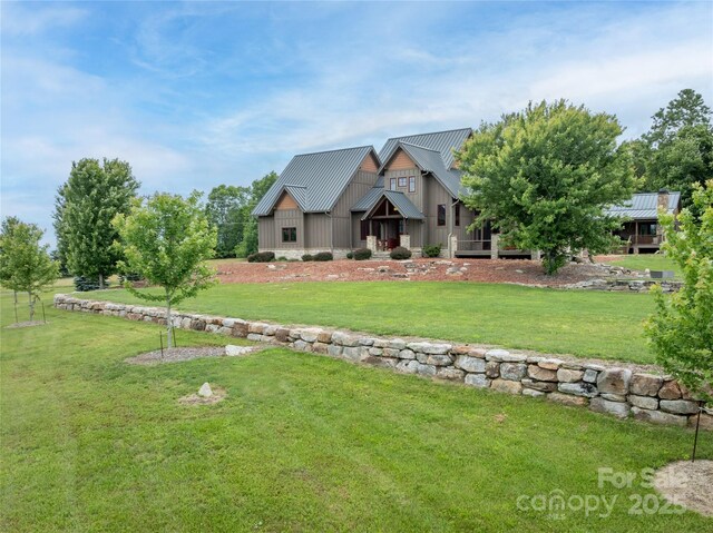 4862 Pinnacle Mountain Rd, Zirconia, NC 28790 - view of front of home featuring board and batten siding, a front yard, and a metal roof