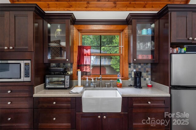 4862 Pinnacle Mountain Rd, Zirconia, NC 28790 - kitchen with appliances with stainless steel finishes, dark brown cabinets, tasteful backsplash, and light countertops