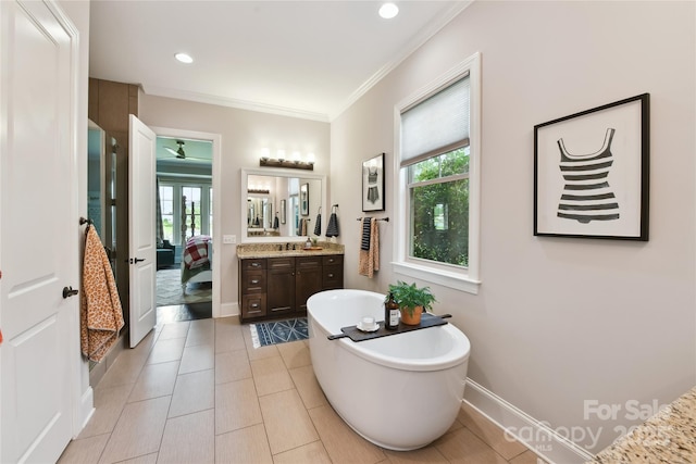 164 Twin Sisters Ln, Mooresville, NC 28117 - full bathroom featuring a freestanding bath, vanity, ornamental molding, connected bathroom, and baseboards