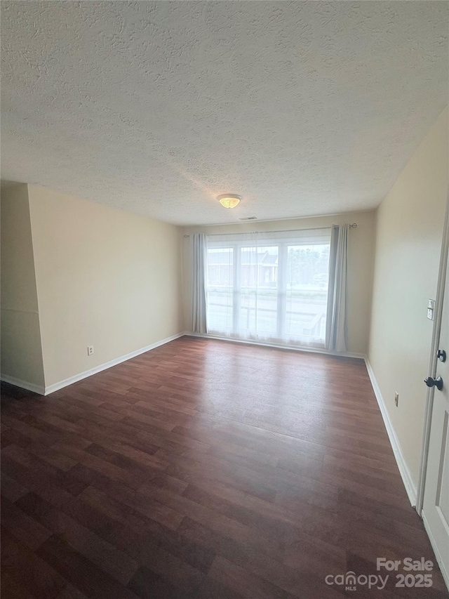 300 N Watterson St, Kings Mountain, NC 28086 - empty room featuring wood finished floors, a textured ceiling, and baseboards