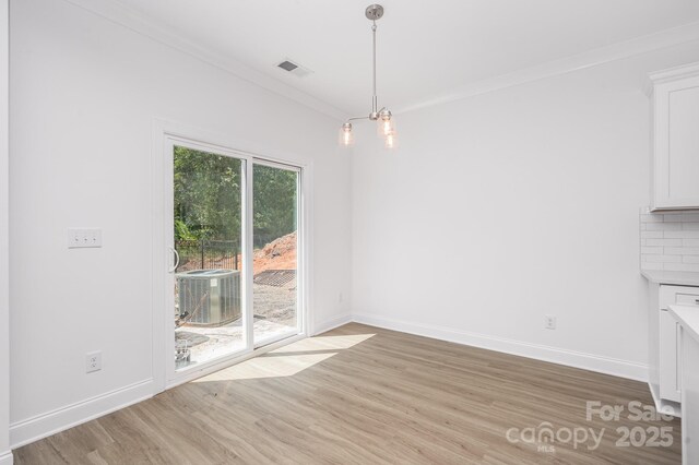 1807 Country Club Rd, Lincolnton, NC 28092 - unfurnished dining area with light wood-style floors, baseboards, and ornamental molding