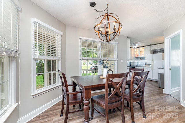 1626 Riverglenn Ct, Rock Hill, SC 29732 - dining space with a chandelier, light wood finished floors, plenty of natural light, and baseboards