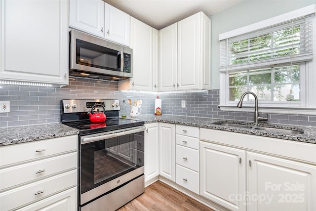 1626 Riverglenn Ct, Rock Hill, SC 29732 - kitchen with stainless steel appliances, a sink, decorative backsplash, and white cabinetry