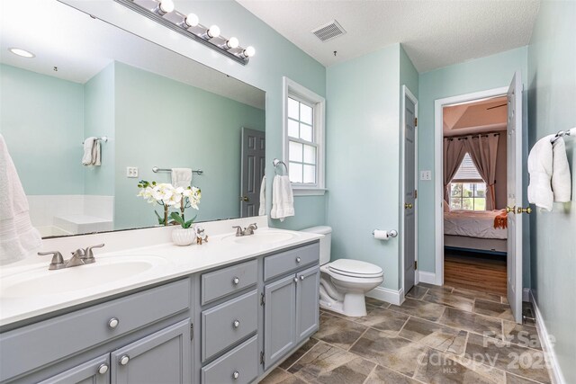 1626 Riverglenn Ct, Rock Hill, SC 29732 - full bathroom featuring double vanity, toilet, baseboards, and ensuite bath