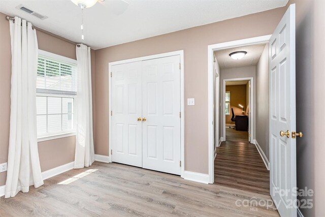 1626 Riverglenn Ct, Rock Hill, SC 29732 - unfurnished bedroom with light wood-style flooring, baseboards, a closet, and a ceiling fan