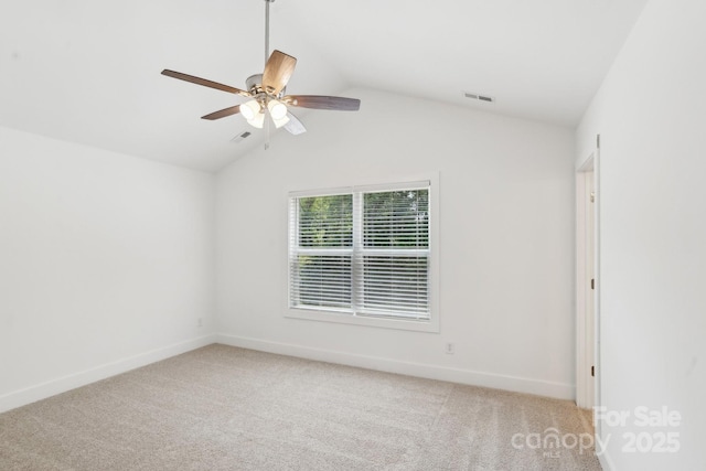 401 W Charlotte Ave, Mount Holly, NC 28120 - spare room with ceiling fan, light carpet, vaulted ceiling, and baseboards