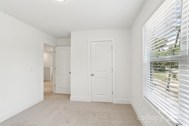 401 W Charlotte Ave, Mount Holly, NC 28120 - unfurnished bedroom with light carpet and baseboards