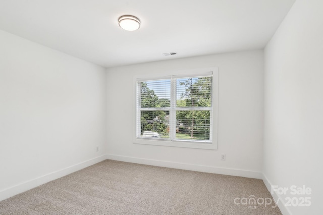 401 W Charlotte Ave, Mount Holly, NC 28120 - spare room featuring light carpet and baseboards