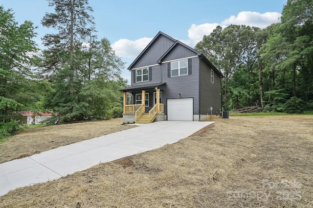 401 W Charlotte Ave, Mount Holly, NC 28120 - view of front facade featuring a garage, concrete driveway, covered porch, and central air condition unit