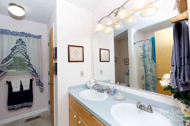 517 Powell St, Rock Hill, SC 29732 - bathroom featuring toilet, double vanity, baseboards, and a shower with shower curtain
