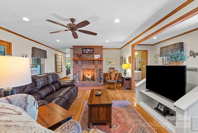 250 Huey Rd, Marshall, NC 28753 - living area featuring ornamental molding, a fireplace, wood finished floors, a ceiling fan, and recessed lighting