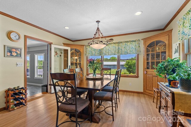 250 Huey Rd, Marshall, NC 28753 - dining space with baseboards, light wood-type flooring, crown molding, recessed lighting, and a textured ceiling