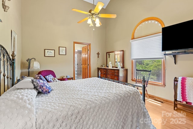 250 Huey Rd, Marshall, NC 28753 - bedroom with a towering ceiling, wood finished floors, baseboards, and connected bathroom