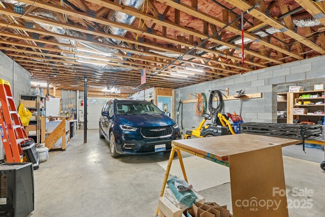250 Huey Rd, Marshall, NC 28753 - garage with concrete block wall and a workshop area