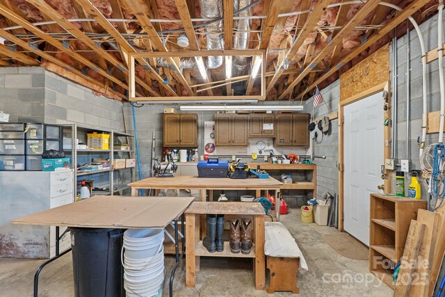 250 Huey Rd, Marshall, NC 28753 - below grade area featuring a workshop area and concrete block wall