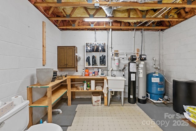 250 Huey Rd, Marshall, NC 28753 - unfinished below grade area with a water pressure tank and concrete block wall