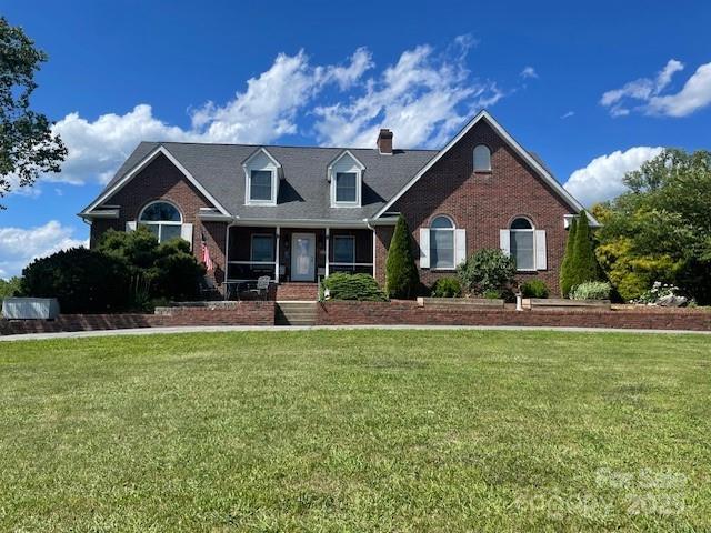 250 Huey Rd, Marshall, NC 28753 - view of front facade featuring brick siding, a chimney, and a front yard