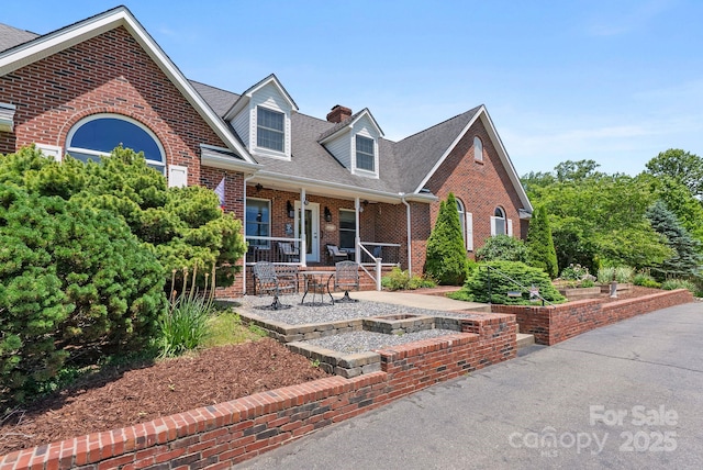250 Huey Rd, Marshall, NC 28753 - view of front facade with brick siding, covered porch, a chimney, and roof with shingles