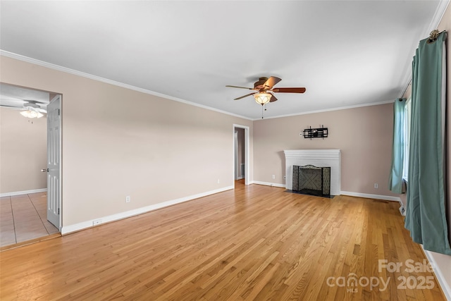 1125 Windy Acres St, Morganton, NC 28655 - unfurnished living room featuring ceiling fan, a fireplace with flush hearth, light wood-style floors, baseboards, and crown molding