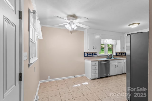 1125 Windy Acres St, Morganton, NC 28655 - kitchen featuring appliances with stainless steel finishes, light countertops, white cabinets, a ceiling fan, and crown molding