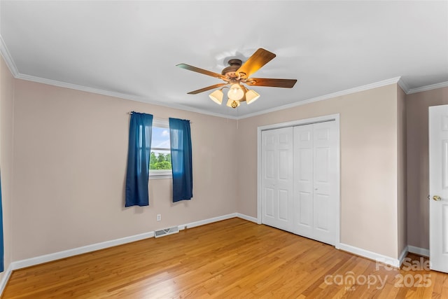 1125 Windy Acres St, Morganton, NC 28655 - unfurnished bedroom featuring light wood-type flooring, baseboards, a closet, crown molding, and a ceiling fan