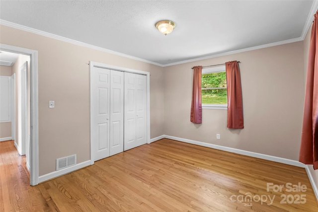1125 Windy Acres St, Morganton, NC 28655 - unfurnished bedroom with light wood-type flooring, baseboards, a closet, and crown molding