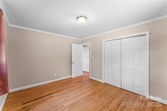 1125 Windy Acres St, Morganton, NC 28655 - unfurnished bedroom featuring light wood-style floors, ornamental molding, baseboards, and a closet