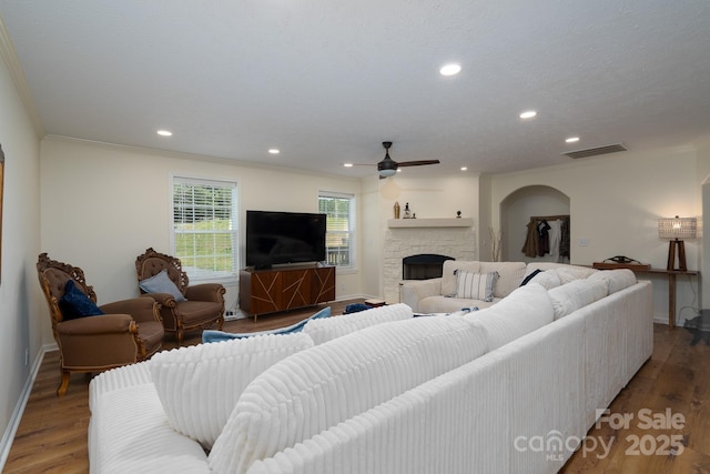 16132 Mclester Rd, Oakboro, NC 28129 - living area featuring ornamental molding, baseboards, a fireplace, a ceiling fan, and wood finished floors