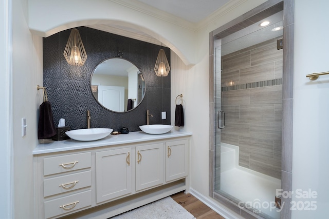 16132 Mclester Rd, Oakboro, NC 28129 - bathroom featuring double vanity, a shower stall, ornamental molding, and wood finished floors