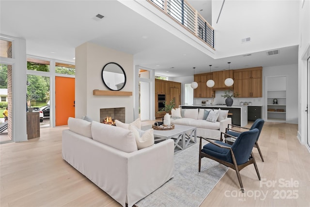 3822 Topsfield Rd, Charlotte, NC 28211 - living room with light wood-style flooring and a lit fireplace