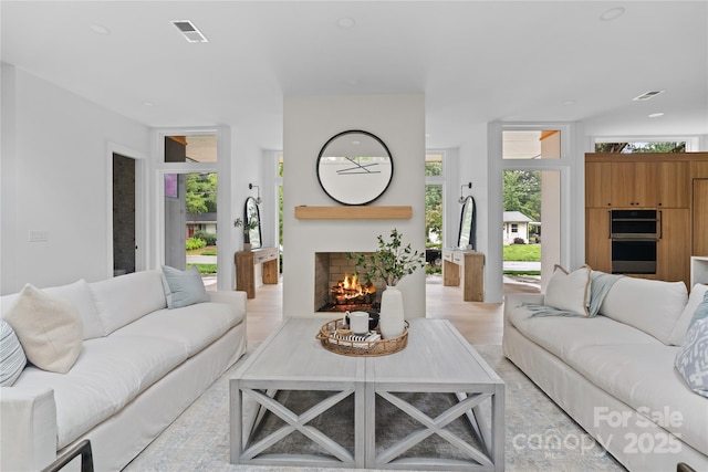 3822 Topsfield Rd, Charlotte, NC 28211 - living area with a lit fireplace, healthy amount of natural light, and light wood-type flooring