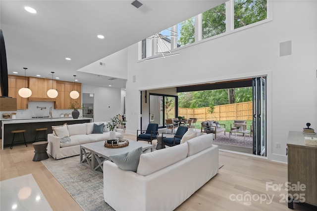 3822 Topsfield Rd, Charlotte, NC 28211 - living area with a towering ceiling, light wood finished floors, and recessed lighting