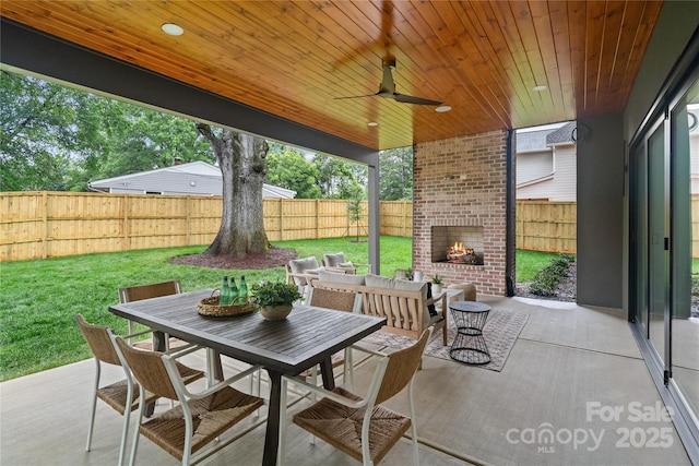 3822 Topsfield Rd, Charlotte, NC 28211 - fenced backyard featuring an outdoor brick fireplace, a patio, and outdoor dining area