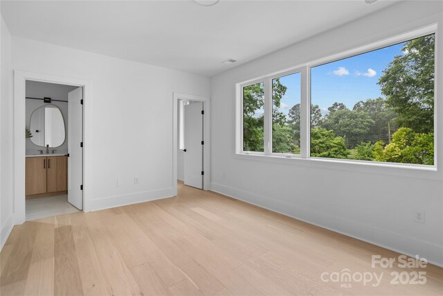 3822 Topsfield Rd, Charlotte, NC 28211 - unfurnished bedroom with baseboards and light wood-type flooring