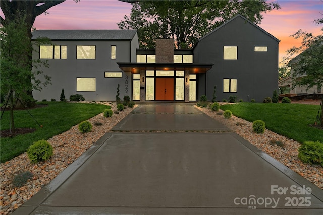 3822 Topsfield Rd, Charlotte, NC 28211 - view of front of house with a front lawn, driveway, and stucco siding