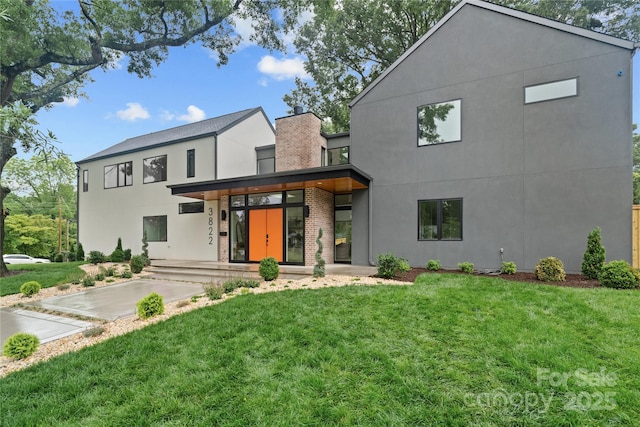 3822 Topsfield Rd, Charlotte, NC 28211 - contemporary home featuring stucco siding, a front lawn, and brick siding