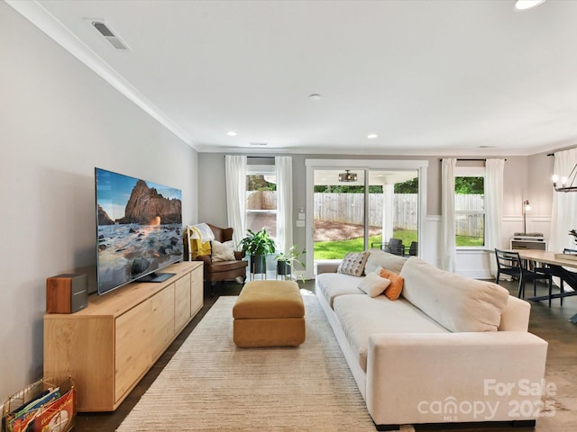 2517 Marlowe Ave, Charlotte, NC 28208 - living area featuring ornamental molding, plenty of natural light, wood finished floors, and recessed lighting