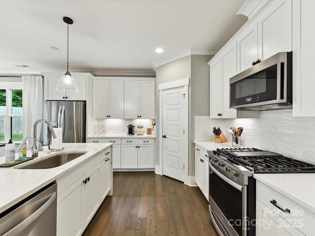 2517 Marlowe Ave, Charlotte, NC 28208 - kitchen with appliances with stainless steel finishes, a sink, white cabinetry, tasteful backsplash, and hanging light fixtures