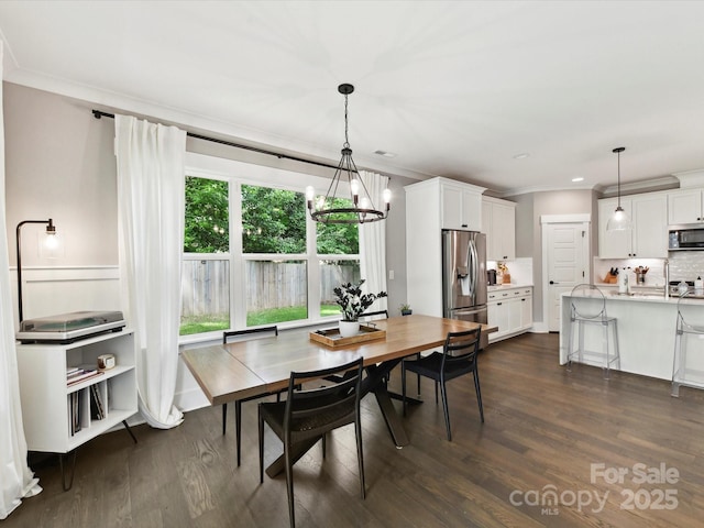 2517 Marlowe Ave, Charlotte, NC 28208 - dining space featuring a chandelier, dark wood-style floors, crown molding, and recessed lighting
