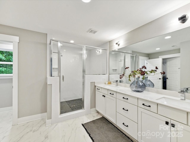 2517 Marlowe Ave, Charlotte, NC 28208 - bathroom featuring a shower stall, double vanity, baseboards, recessed lighting, and marble look tiles