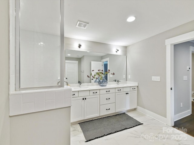 2517 Marlowe Ave, Charlotte, NC 28208 - full bath featuring marble look tile flooring, double vanity, baseboards, and recessed lighting