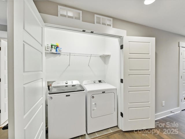 2517 Marlowe Ave, Charlotte, NC 28208 - laundry area featuring separate washer and dryer, wood finished floors, and baseboards