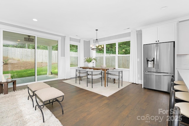 2517 Marlowe Ave, Charlotte, NC 28208 - dining space featuring dark wood-style flooring, healthy amount of natural light, a chandelier, crown molding, and recessed lighting