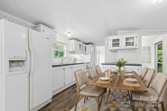 1884 Kensway Dr, Hudson, NC 28638 - dining area featuring vaulted ceiling, dark wood-type flooring, and wallpapered walls