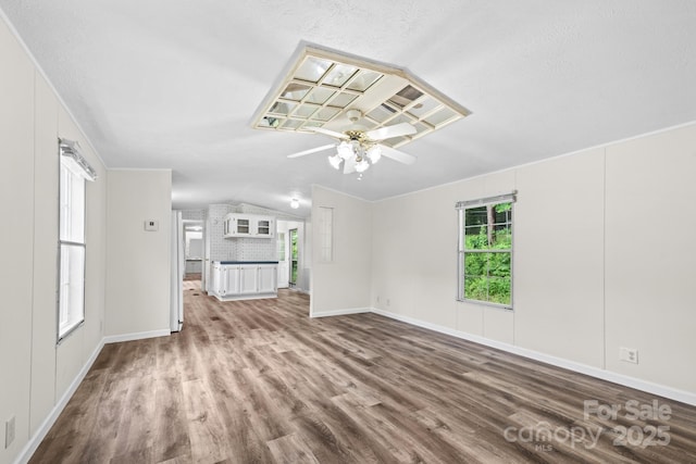 1884 Kensway Dr, Hudson, NC 28638 - unfurnished living room with wood finished floors, ceiling fan, baseboards, and lofted ceiling