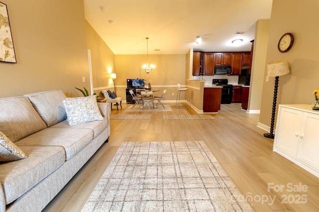 11867 Ridgeway Park Dr, Charlotte, NC 28277 - living room with light wood-style floors and a chandelier